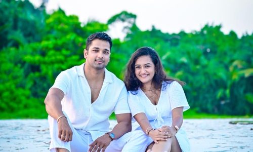 Romantic couple sitting on a beautiful Andaman beach during sunset Couple enjoying a romantic beach walk in Andaman Nicobar Islands